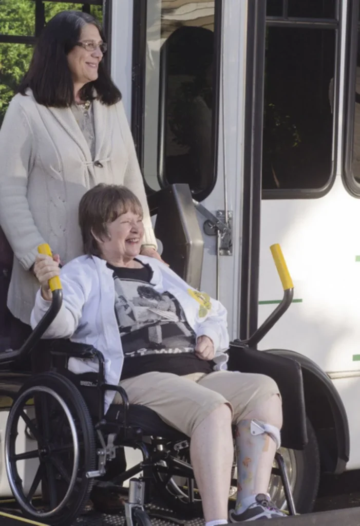 Caregiver assisting a senior woman in a wheelchair outside, representing compassionate senior care for Sun City Summerlin residents