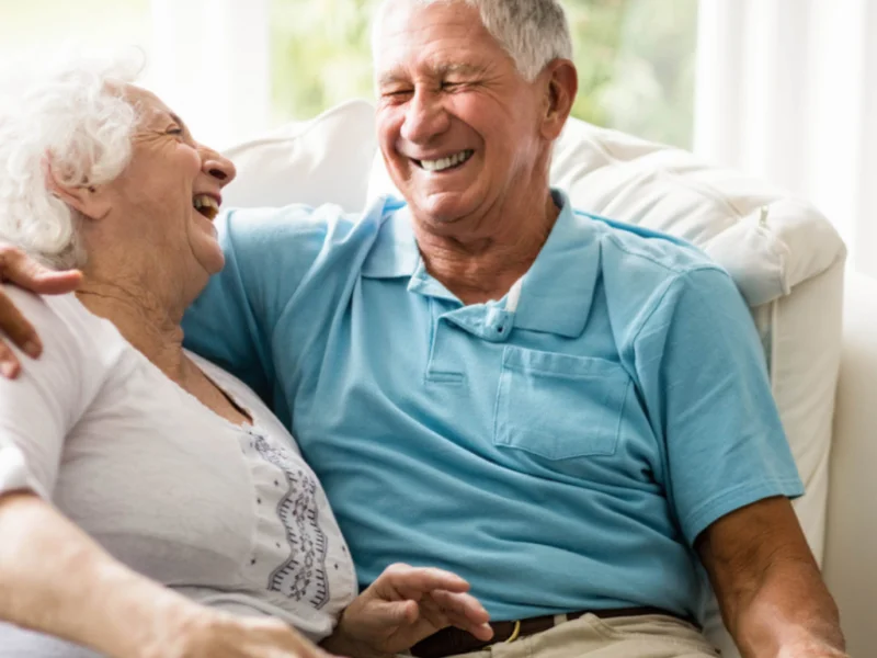 Happy senior couple laughing together at home, representing compassionate senior home care in Mesquite, Nevada