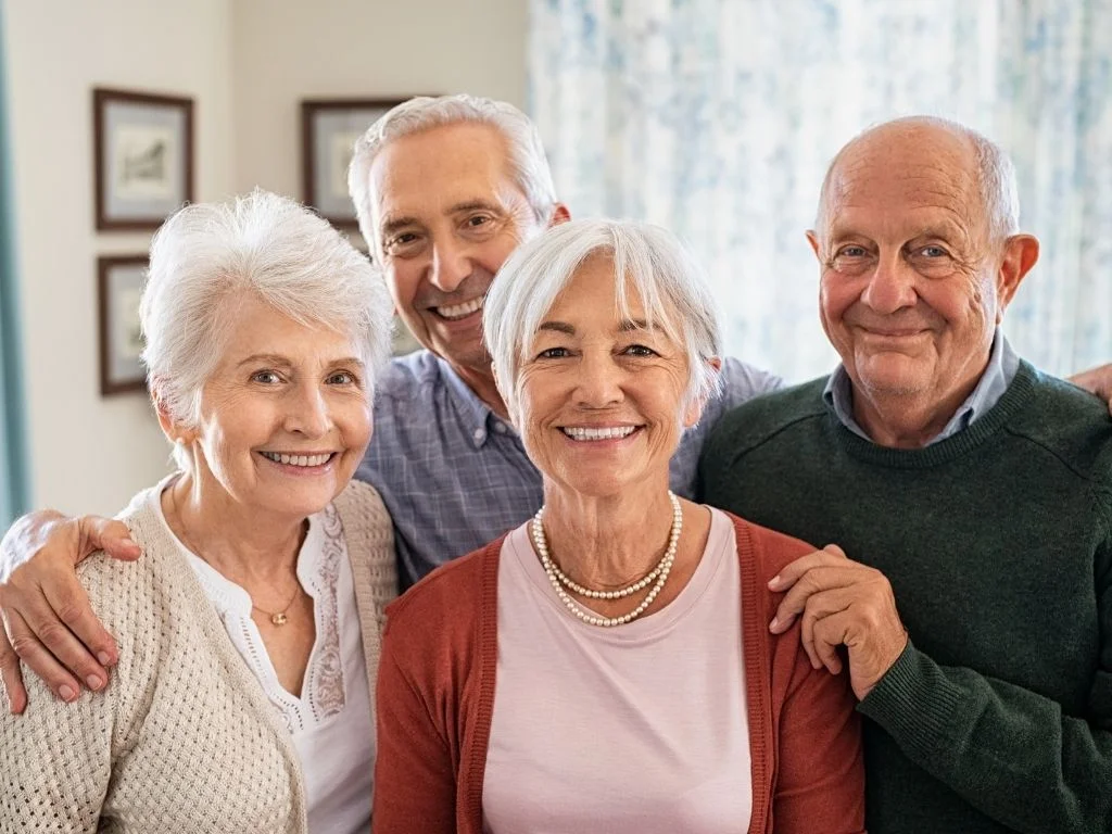 Smiling group of seniors receiving reliable long-term care support and comfort at home