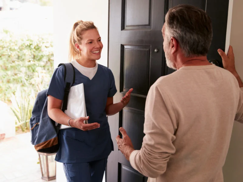 Caregiver arriving at a senior’s home to provide respite care and support for family caregivers