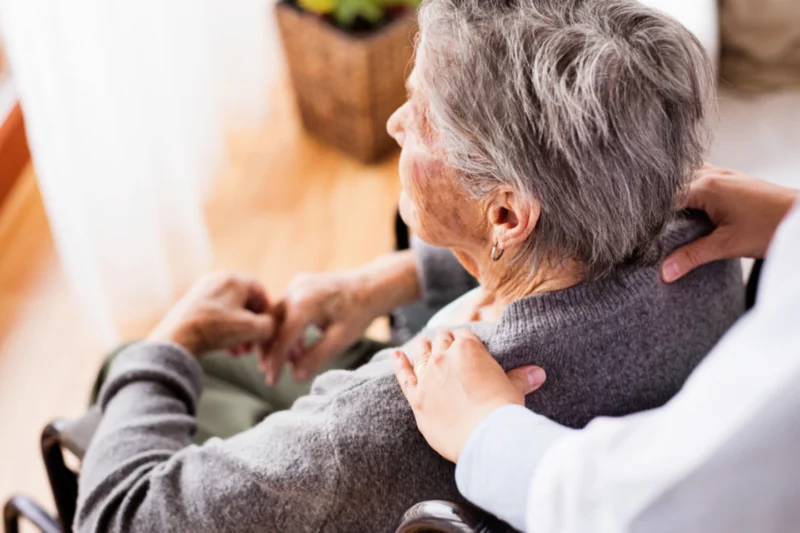Caregiver providing compassionate support to an elderly woman at My Essential Care in Boulder City NV