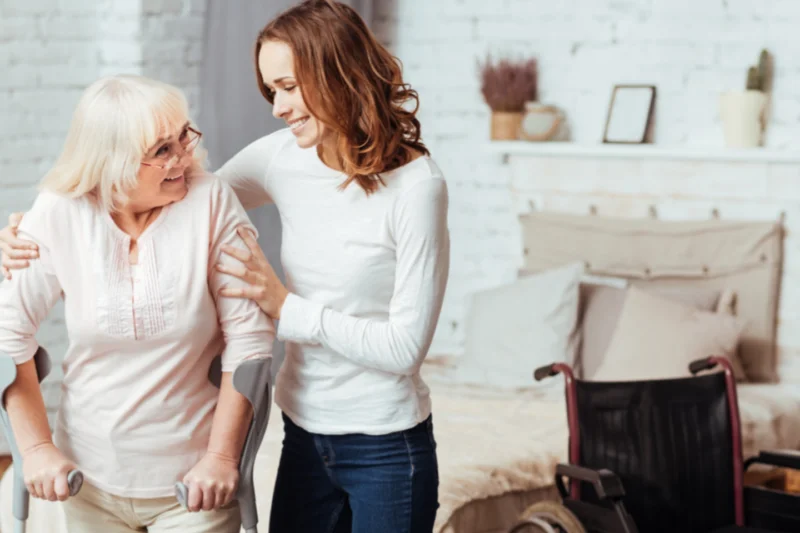 Caregiver supporting an elderly woman with mobility assistance at home, representing trusted senior home care in Lake Las Vegas, Nevada
