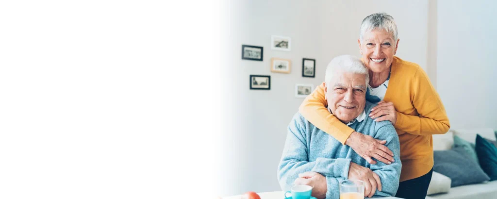 Smiling senior couple embracing at home, representing dignity, comfort, and high-quality professional home care services