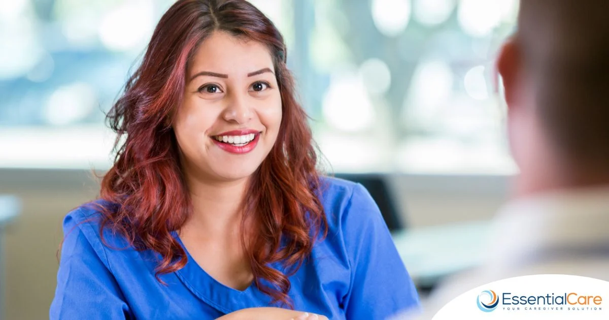 Smiling caregiver during an interview, representing key traits agencies look for in caregiver applicants