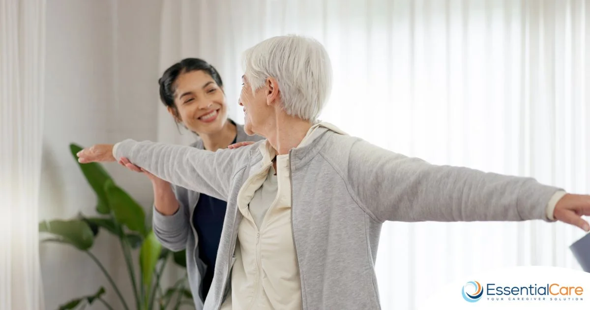 Caregiver assisting a senior with gentle exercise as part of engaging and stimulating at-home activities